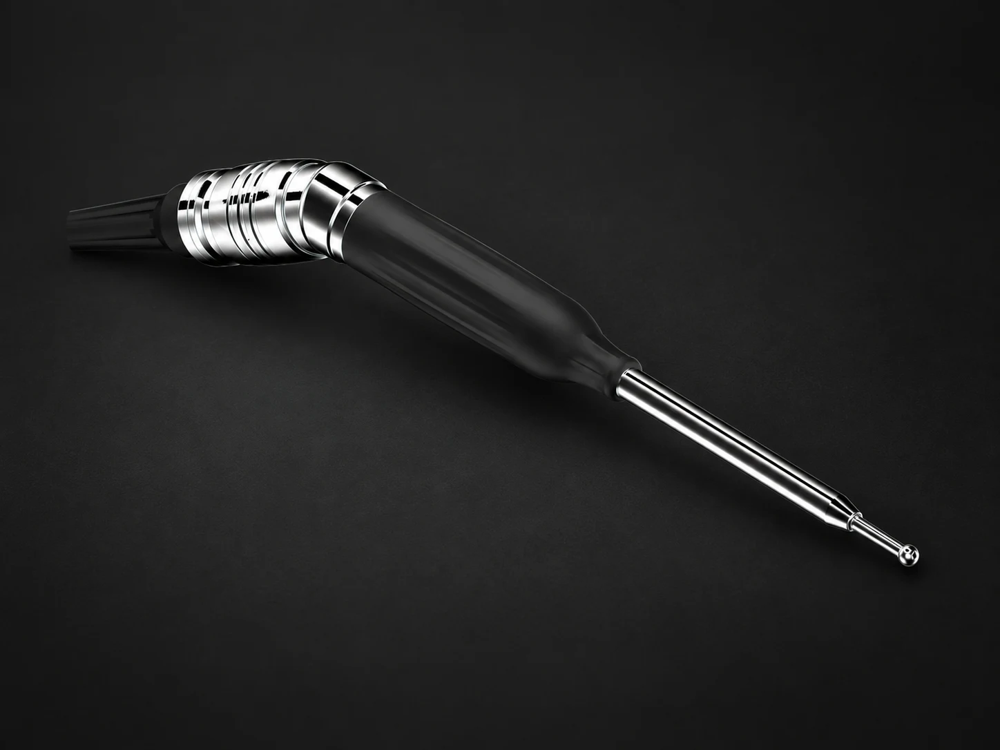 Burrow handpiece on a dark studio background